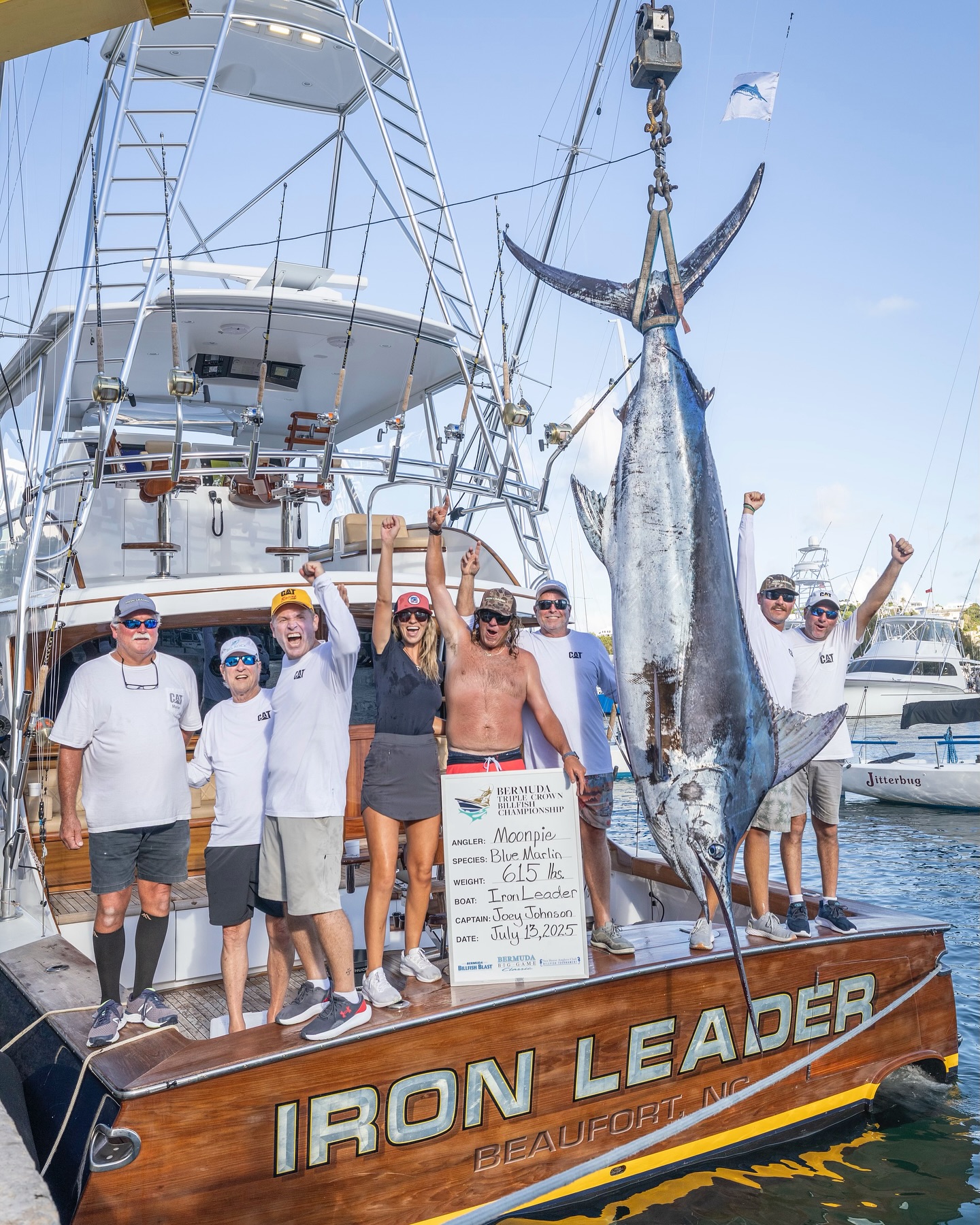 Iron Leader team celebrating on the dock with a 615 lb blue marlin catch by angler 'Moonpie' during the 2025 Bermuda Big Game Classic