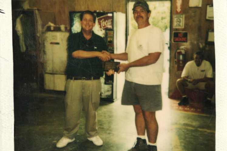 Randy Ramsey honoring Brian Wade as employee of the month in 1998